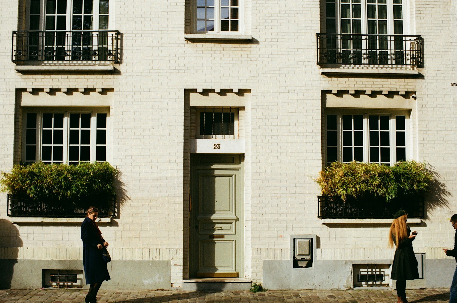 people standing in front of white concrete building during daytime